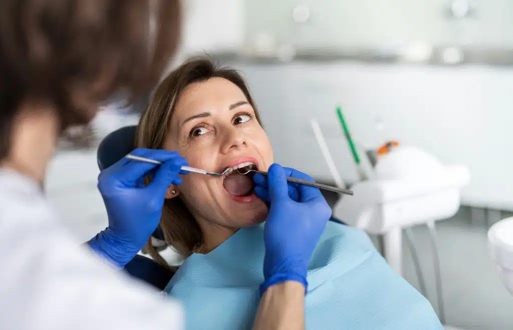 A dentist examining a woman's teeth