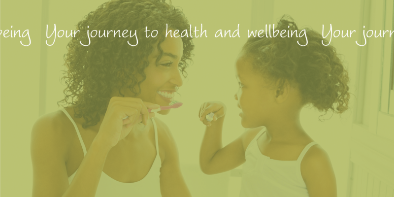 A woman and a child brushing their teeth