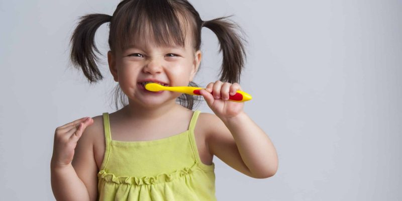 child brushing teeth